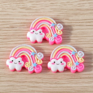 Detail of DIY resin charms featuring smiling clouds, rainbow bridges and blue stars