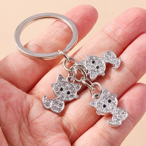 Sparkling silver diamond cat keychain with three rhinestone-encrusted feline charms