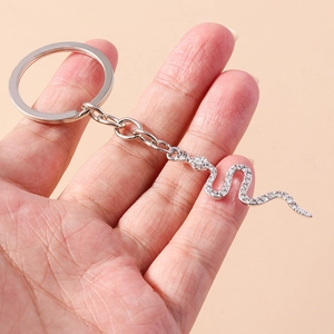 Handheld silver keychain featuring a creative snake pendant encrusted with sparkling crystals