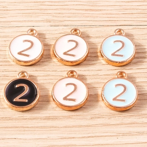 Macro shot of colorful enamel alloy round charms with golden number two for DIY jewelry