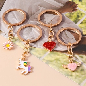 Cute cartoon keychain set with unicorn, flowers, and sequined hearts on golden plating