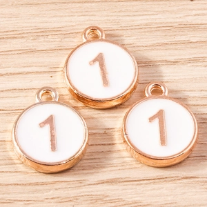 Detailed macro view of white enamel and rose gold number 1 round alloy charms
