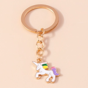 Detail of a golden unicorn keychain with colorful enamel mane and metal ring attachment