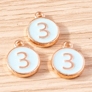 Detail of rose gold number 3 pendants with blue enamel for DIY jewelry making