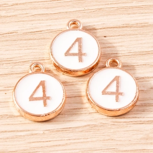 Macro detail of number 4 alloy pendant with rose gold plating and white enamel finish