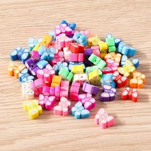 Detailed macro view of colorful butterfly polymer clay beads with small floral patterns