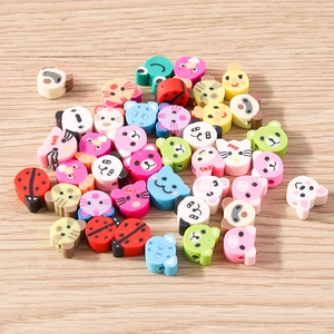 Close-up of colorful animal polymer clay beads including panda and frog for DIY crafts