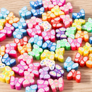 Macro shot of assorted colorful butterfly polymer clay beads with floral pattern for DIY