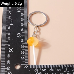 Detailed size measurement of a yellow lollipop keychain with silver metal ring
