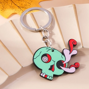 Porte-clés tête de mort vert menthe avec motif fumée sur plateau d'exposition beige