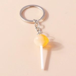 Detailed view of creative lollipop keychain with yellow resin swirl and silver ring