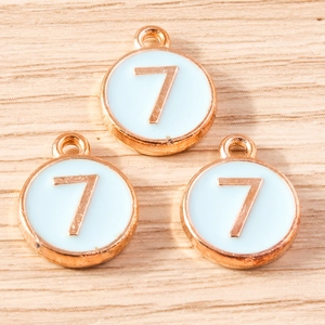 Close-up of number 7 alloy pendants in rose gold finish with light blue enamel detail
