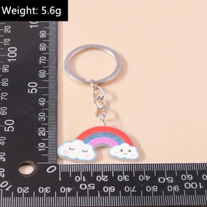 Portachiavi arcobaleno con nuvole sorridenti in resina glitterata, peso indicato di 5,6g