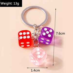 Detailed view of 13g acrylic resin dice keychain featuring red, purple, and pink cubes