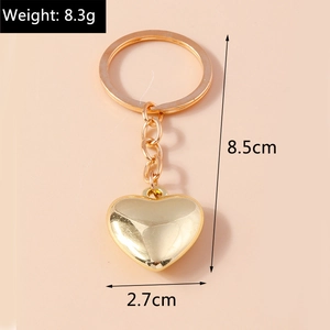 Portachiavi a cuore dorato lucido con dimensioni lunghezza totale 8,5 cm e larghezza 2,7 cm