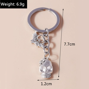 Detail of silver skull keychain with bat pendant, weight 6.9g and length 7.7cm