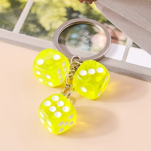 Detail view of fluorescent green acrylic dice keychain with silver metal ring and chain