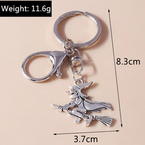 Detailed view of silver witch on broom keychain with size markings 8.3cm and 11.6g weight
