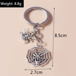 Detail of silver vintage spider and web charms on a metal keychain with size specs