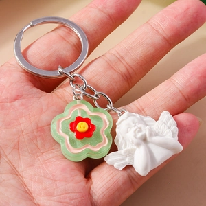 Cute angel keychain with green flower pendant and white resin cherub charm
