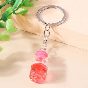 Schlüsselanhänger Treibflasche mit Muscheln, Trockenblumen und rosa Flüssigkeit