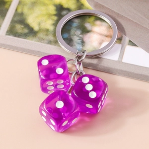 Close-up of three purple transparent acrylic dice charms with a silver keychain ring