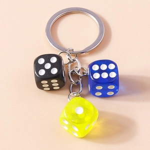 Detail view of colorful acrylic dice keychain with black, blue, and yellow charms