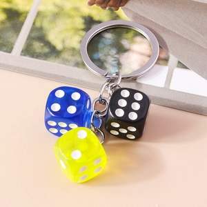 Detailed shot of resin dice keychain featuring blue, yellow, and black acrylic cubes
