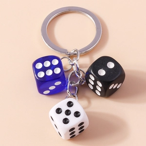 Detail of creative keychain featuring blue, black, and white acrylic dice charms