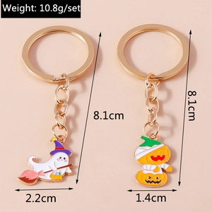 Detail view of Halloween keychains showing ghost and mummy pumpkin charms with measurements