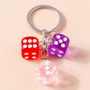 Macro view of colorful acrylic resin dice keychain with silver metal rings and chains