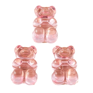 Pink translucent resin gummy bear pendants for DIY jewelry making on white background