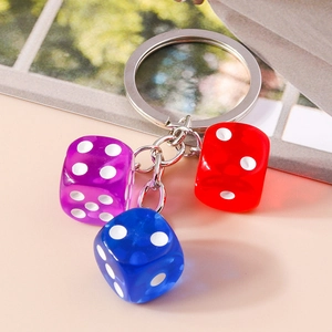 Detail of colorful acrylic resin dice keychain featuring red, blue and purple pendants