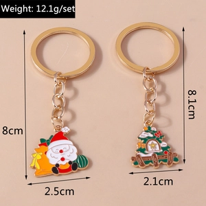 Christmas keychain set featuring Santa and tree charms with gold rings and size labels