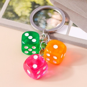 Close-up of translucent colorful acrylic dice charms on a silver metal keychain ring