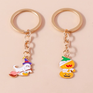 Detail view of Halloween pumpkin mummy and ghost witch charms on gold keyrings