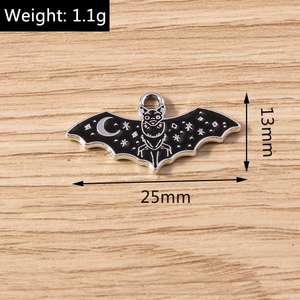 Detailed view of black enamel bat pendant with moon and star patterns for DIY jewelry