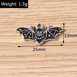 Detailed macro view of black enamel bat pendant with moon and stars starry sky design