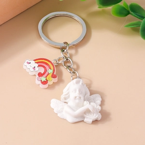Detail of cute angel keychain with rainbow charm and white cupid resin figure