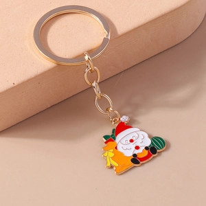 Golden Christmas keychain with enamel Santa Claus pendant on minimalist stand