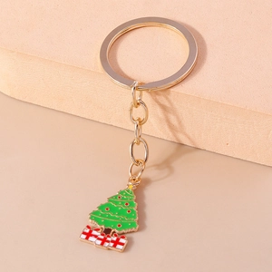 Golden Christmas keychain featuring a green tree and gift box charms for festive decoration