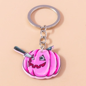 Pink acrylic Halloween pumpkin keychain with spooky knife and bloody detail for bags