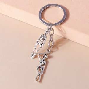 Detailed close-up of vintage silver skull pendants on a metal keychain ring