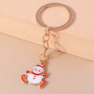 Cartoon Christmas snowman keychain with gold metal ring and vibrant enamel ski pendant