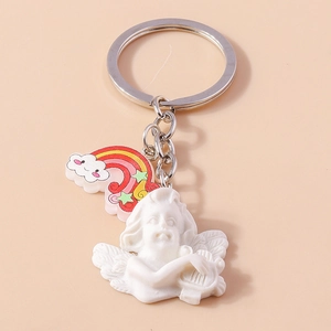 Close-up of cute angel keychain with rainbow cloud and harp-playing cupid charm