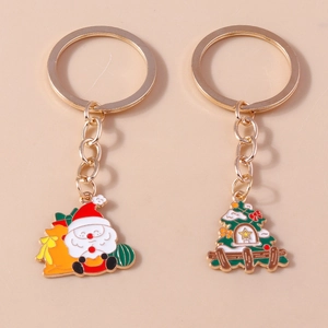 Detailed view of Santa Claus and Christmas tree gold alloy keychain set in vibrant colors