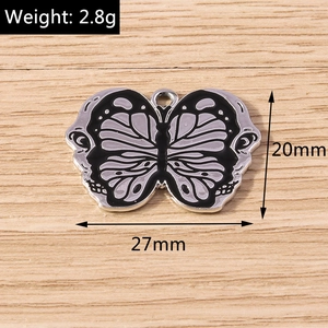 Detail of a dark butterfly charm pendant for DIY jewelry showing 27mm width and 20mm height