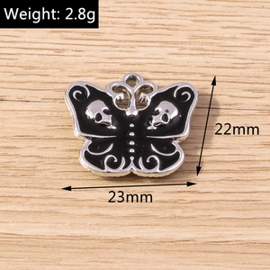 Macro detail of a 23mm Gothic butterfly pendant with black enamel skull wings for DIY jewelry