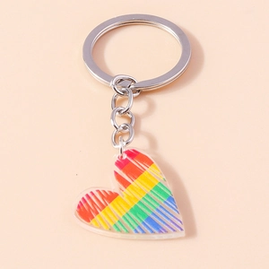 Primo piano del portachiavi in acrilico a forma di cuore con vivaci strisce arcobaleno