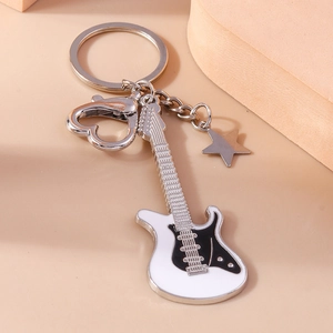 Cartoon electric guitar keychain with heart clasp and star pendant on beige background